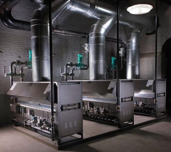 Triplex 1,000,000 BTU Boilers: The system heats a water source heat pump loop serving an industrial mill complex.